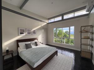 a bedroom with a large bed and a large window at Kalma - 2 Bedroom Villa with Private Pool in Santander