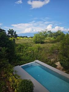 a swimming pool in the middle of a field at Kalma - 2 Bedroom Villa with Private Pool in Santander
