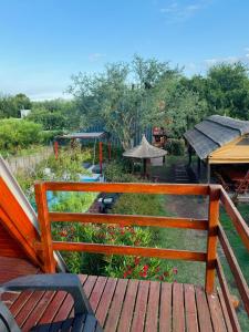 a wooden bench sitting on top of a deck at Cabañas Las abuelas in Villa Rumipal +7 photos