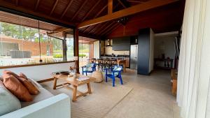 a living room with a white couch and a table at Casa 09 Monte Boa Vista - Refúgio com Piscina Privativa, Sauna e Vista das Montanhas in Teresópolis