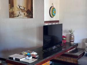 a living room with a flat screen tv on a table at Splendide villa à morro branco vue sur mer in Beberibe