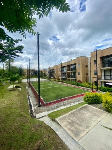a tennis net in front of a building at Apartamento con piscinas y jacuzzi in La Tebaida