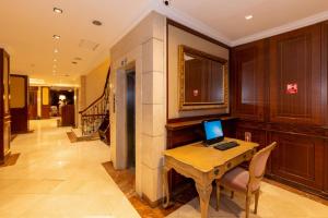 a laptop computer sitting on a wooden table in a hallway at Taksim Pera Rose Hotel & Spa - Istiklal Street in Istanbul