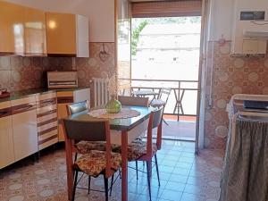 a kitchen with a table and chairs and a kitchen with a window at Appartamento inCentro in Popoli