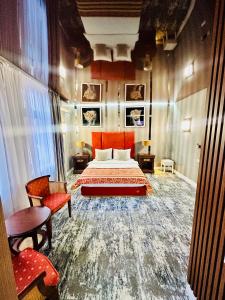 a hotel room with a bed and a chair at Villa & Restaurant Levoslav House in Sibiu