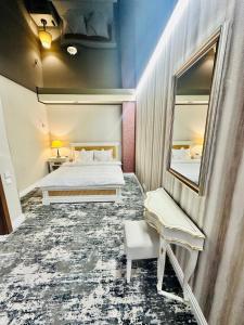 a bedroom with a bed and a mirror at Villa & Restaurant Levoslav House in Sibiu