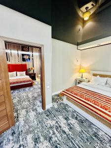 a bedroom with two beds and a mirror at Villa & Restaurant Levoslav House in Sibiu