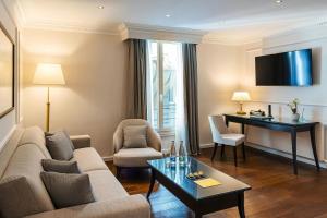 a living room with a couch and a table at Grand Hotel Suisse Majestic, Autograph Collection in Montreux