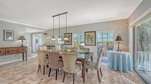 a dining room with a table and chairs at Hemingway House - 117 in Siesta Key