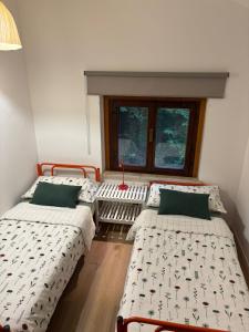 ヴェンゾーネにあるL'Intermezzoのベッドが3つと窓のある部屋