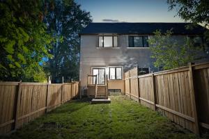 a house with a wooden fence in front of it at Brand new custom 4BR house in Oshawa
