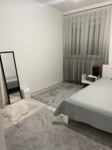 a bedroom being remodeled with a bed and a mirror at Flat in Fushë Kosova in Kosovo Polje