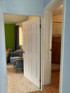 an open door into a living room with a blue couch at Apartamento la 20 in Tijuana