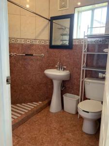 a bathroom with a toilet and a sink at Apartamento la 20 in Tijuana +7 photos