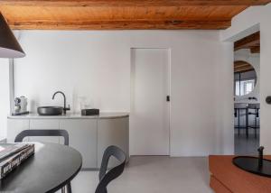 una cucina con pareti bianche e soffitto in legno di Clementine House a Cesky Krumlov Altre 32 foto