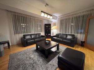 a living room with a couch and a coffee table at La Residenza in Craiova