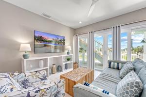 a living room with a couch and a tv at Beach Fanta Sea - 149 in Bailey Hall