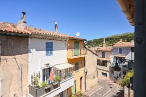 a view of a city street from a building at Oustau de Gemo - Maison confort au cœur de Gémenos in Gémenos