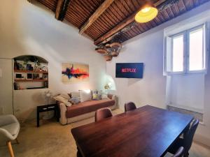 a living room with a table and a couch at Casa Bella in Central Noto, a Unique Sicilian Stay in Noto