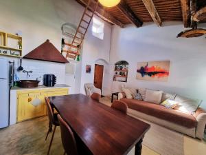 a living room with a couch and a table at Casa Bella in Central Noto, a Unique Sicilian Stay in Noto