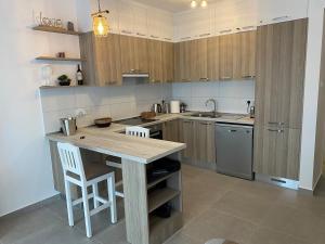a kitchen with wooden cabinets and a wooden counter top at CoveDream Studio Cove Garden Sun Valley Esentepe in Aglantzia