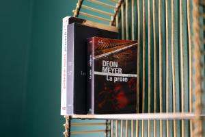 a couple of books sitting on a shelf at Casa Archipel - Lagedos in Ribeira Fria