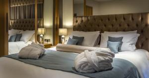 pokój hotelowy z 2 łóżkami i ręcznikami w obiekcie Mansio Suites Basinghall w mieście Leeds