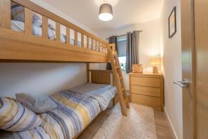 a bedroom with a bunk bed with a ladder at Adwyr-Mynydd in Dinorwic