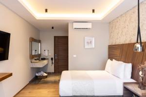 Ένα ή περισσότερα κρεβάτια σε δωμάτιο στο Hotel Boutique Alma