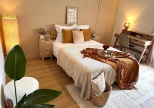 a bedroom with a bed and a desk in it at Fleur Bohème - Hypercentre République - Parking in Le Mans