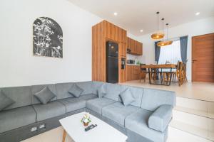 a living room and kitchen with a couch and a table at Villa Kusuma 3 Seminyak in Badung