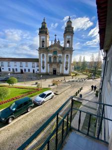 a church with two cars parked in front of it at Casa do Mosteiro in Cabeceiras de Basto