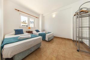 a bedroom with two beds and a ladder at C06 - Water Tower Townhouse in Lagos