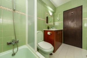 a bathroom with a toilet and a shower and a sink at C06 - Water Tower Townhouse in Lagos +41 photos