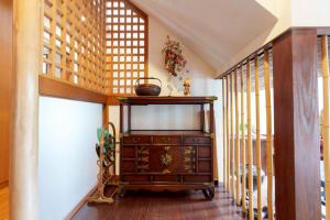 a living room with a dresser and windows at SEBARI casa vacation rental in Kushima