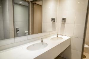 a bathroom with two sinks and a mirror at Cosmic Leopard in Cape Town +29 photos