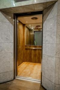 a hallway with a mirror and a room with wood at Cosmic Leopard in Cape Town