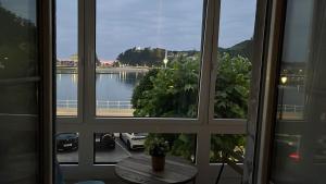 a window with a view of a body of water at Alojamientos Boutique Ribadesella in Ribadesella