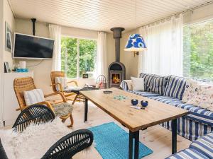 a living room with a couch and a table at Secluded Spa Retreat - By Traum Ferienwohnungen in Lønstrup