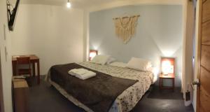 a bedroom with a bed with two towels on it at Hospedaje Hamuy's Lodge in Ica