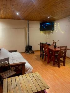 a room with a table and chairs and a tv at LIORA Hostal in Tafí del Valle +10 photos
