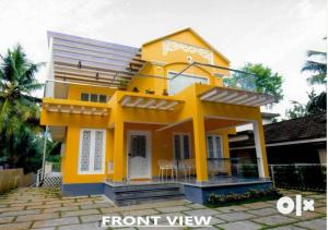 a yellow house with a front view of it at Charis Villa and Guest house 5bed 4bath in kunnamkulam in Kunnamkulam