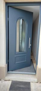 a blue door with a window on it at les colombes in Laquenexy