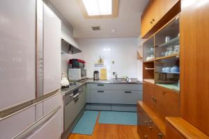 a kitchen with a sink and a stove top oven at SEBARI casa vacation rental in Kushima