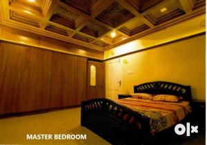 a bedroom with a bed in a room at Charis Villa and Guest house 5bed 4bath in kunnamkulam in Kunnamkulam