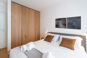 Una cama o camas en una habitación de Stupendo appartamento nel cuore di Bormio con WiFi