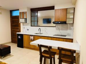 a kitchen with a counter and some chairs in it at Suite in Ibarra