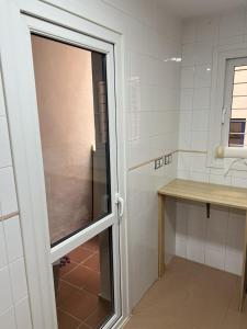 a door to a bathroom with a counter and a sink at Apartamento Playa en Manilva in San Luis de Sabinillas
