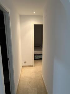 a hallway with a bed in a small room at Apartamento Playa en Manilva in San Luis de Sabinillas +19 photos