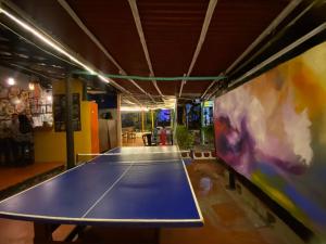 a ping pong table in the middle of a room at Casona Don Juan Hostel in San Gil